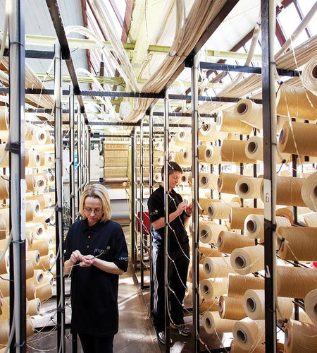 People sorting out racks of wool at Phoenox Textiles