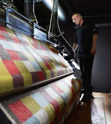 Worker at Phoenox Textiles working on the shearing machine