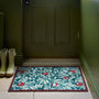 Sanderson By Highgrove x Hug Rug Ancient Apple Tree Midnight with an apple tree design, styled by a green door.