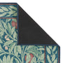 Close-up of Sanderson By Highgrove x Hug Rug Eco-Washable Ancient Apple Tree Midnight with an apple tree design showing rubber backing.