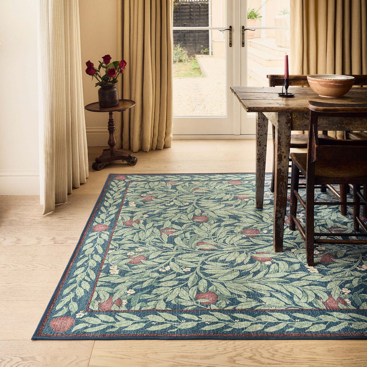 Sanderson By Highgrove x Hug Rug Eco-Washable Ancient Apple Tree Midnight with apple tree design, styled on wooden flooring.