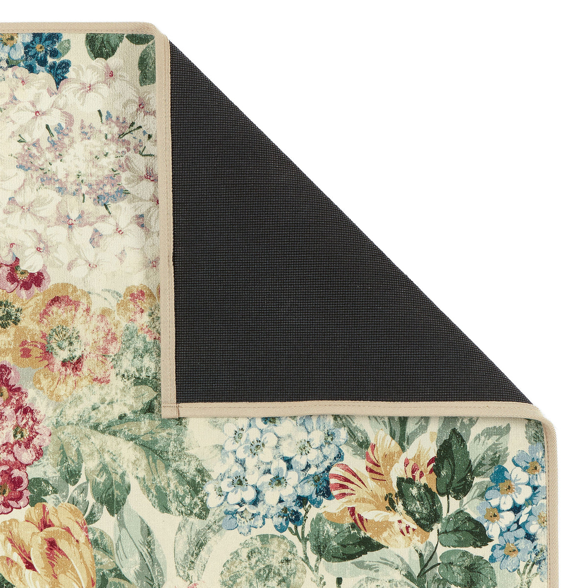 Close-up of Sanderson By Highgrove x Hug Rug Antique Hydrangea & Rose with a floral design showing rubber backing.