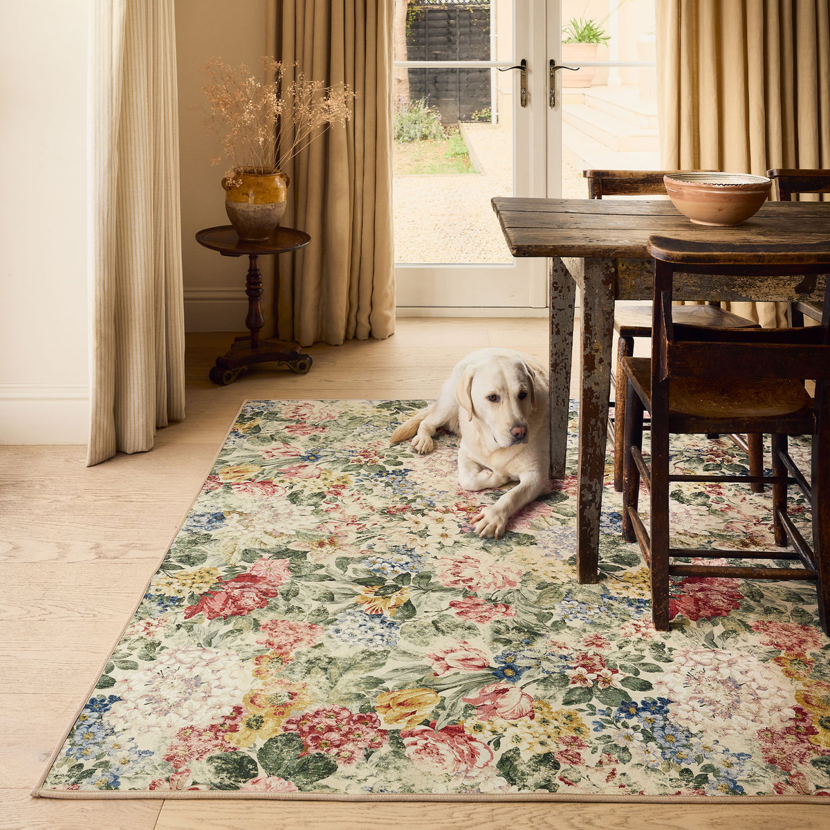 Sanderson By Highgrove x Hug Rug Antique Hydrangea & Rose with a floral design, styled on wooden flooring.