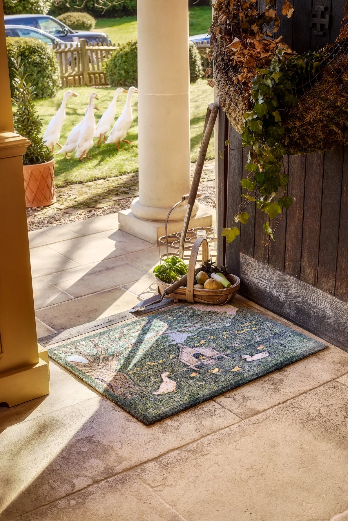 Hug Rug X Sally Swannell Ducks Doormat styled in a doorway 