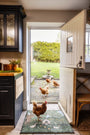 Hug Rug X Sally Swannell Ducks Doormat styled in a doorway with Chickens