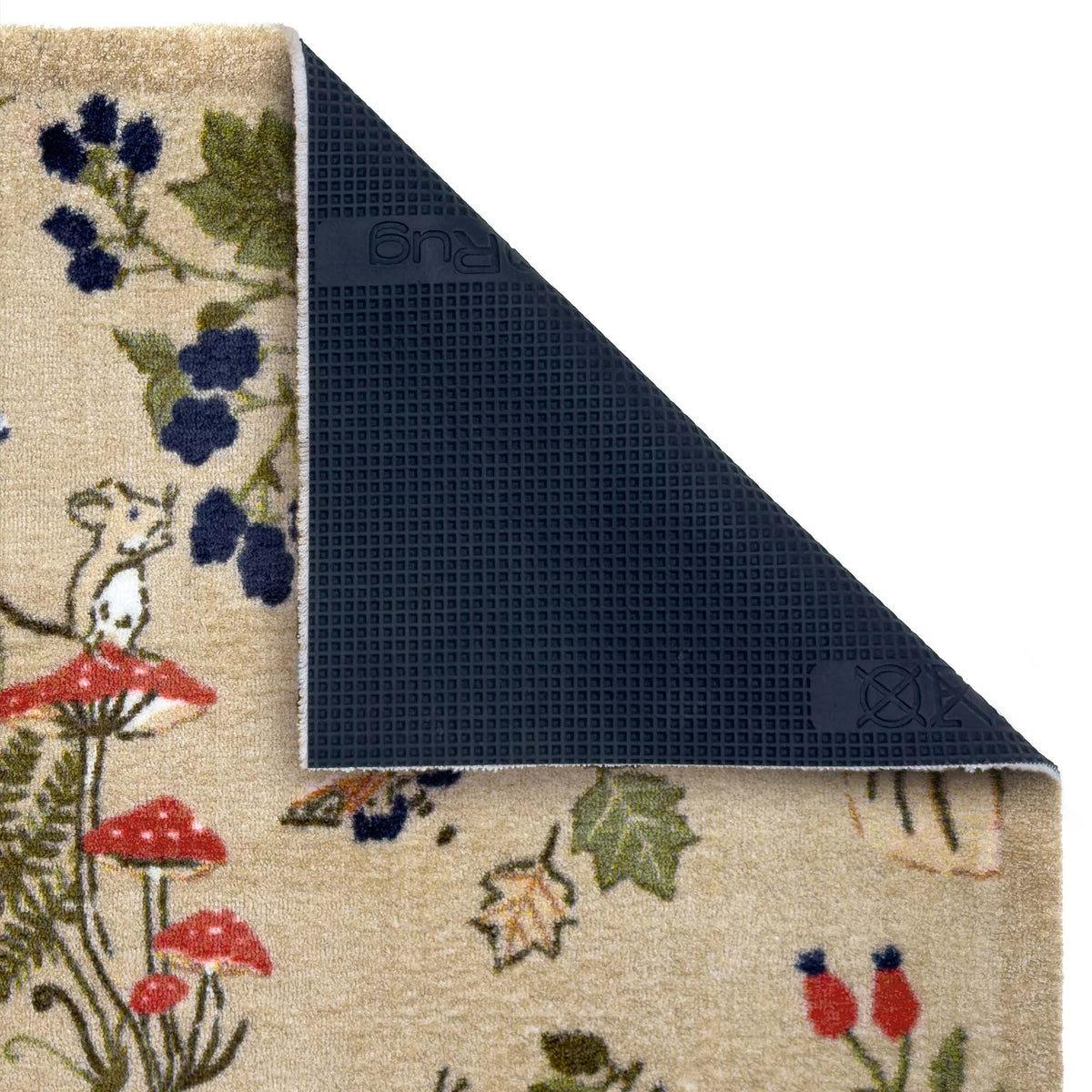A close-up of a patterned rug with a corner folded back to show the dark textured underside. The top surface features a beige base with a whimsical woodland print including a mouse, red mushrooms, blue berries, and green leaves.