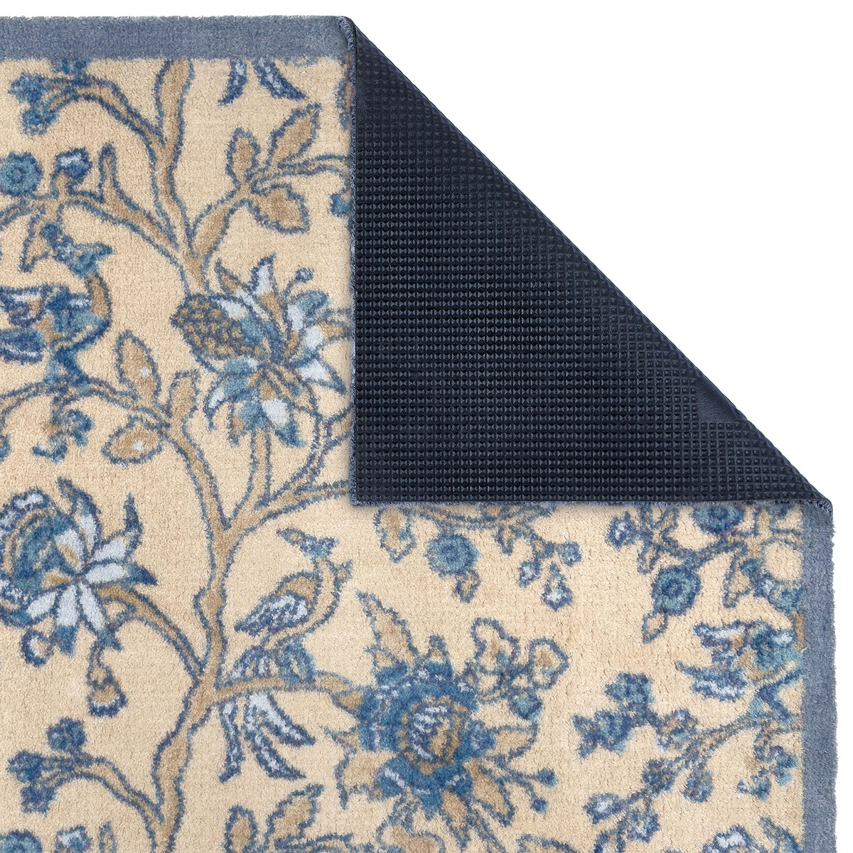 Close-up of Sanderson By Highgrove x Hug Rug Azalea Walk Wedgwood with a blue floral design showing rubber backing.