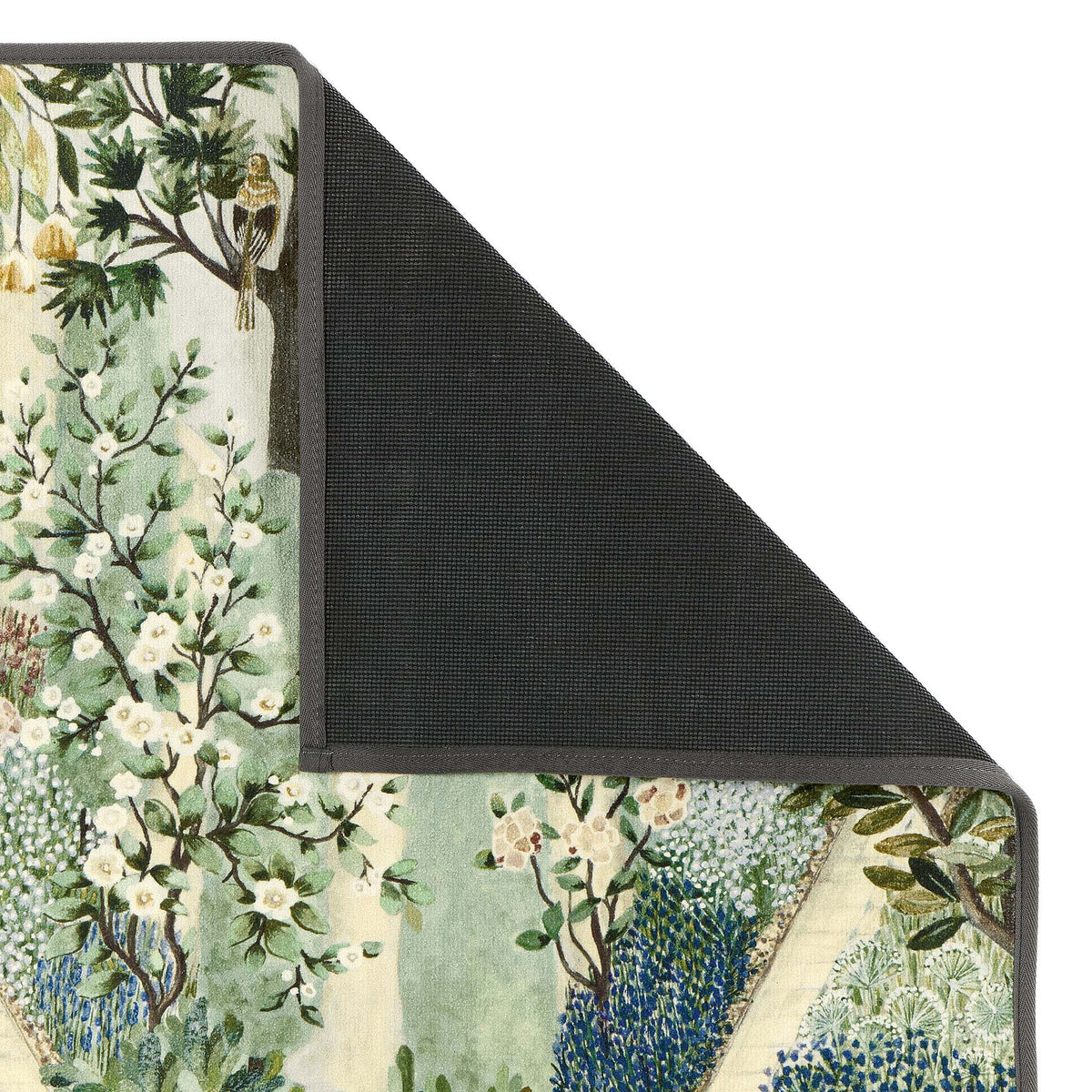 Close-up of Sanderson By Highgrove x Hug Rug Eco-Washable Carpet Garden Sanctuary with a nature inspired pattern showing the rubber backing.