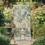 Sanderson By Highgrove x Hug Rug Eco-Washable Carpet Garden Sanctuary Runner with a nature inspired pattern, styled in a garden.