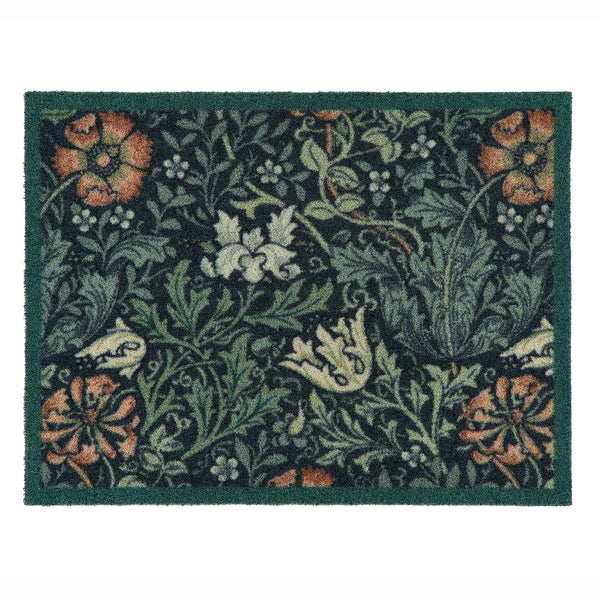 A rectangular outdoor doormat with a dark green border and a dense floral and botanical pattern in muted green, beige, orange, and white on a dark background.