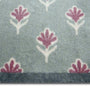 Disty Floral Green- Made from 100% recycled cotton featuring a woodblock pattern of purple flowers.