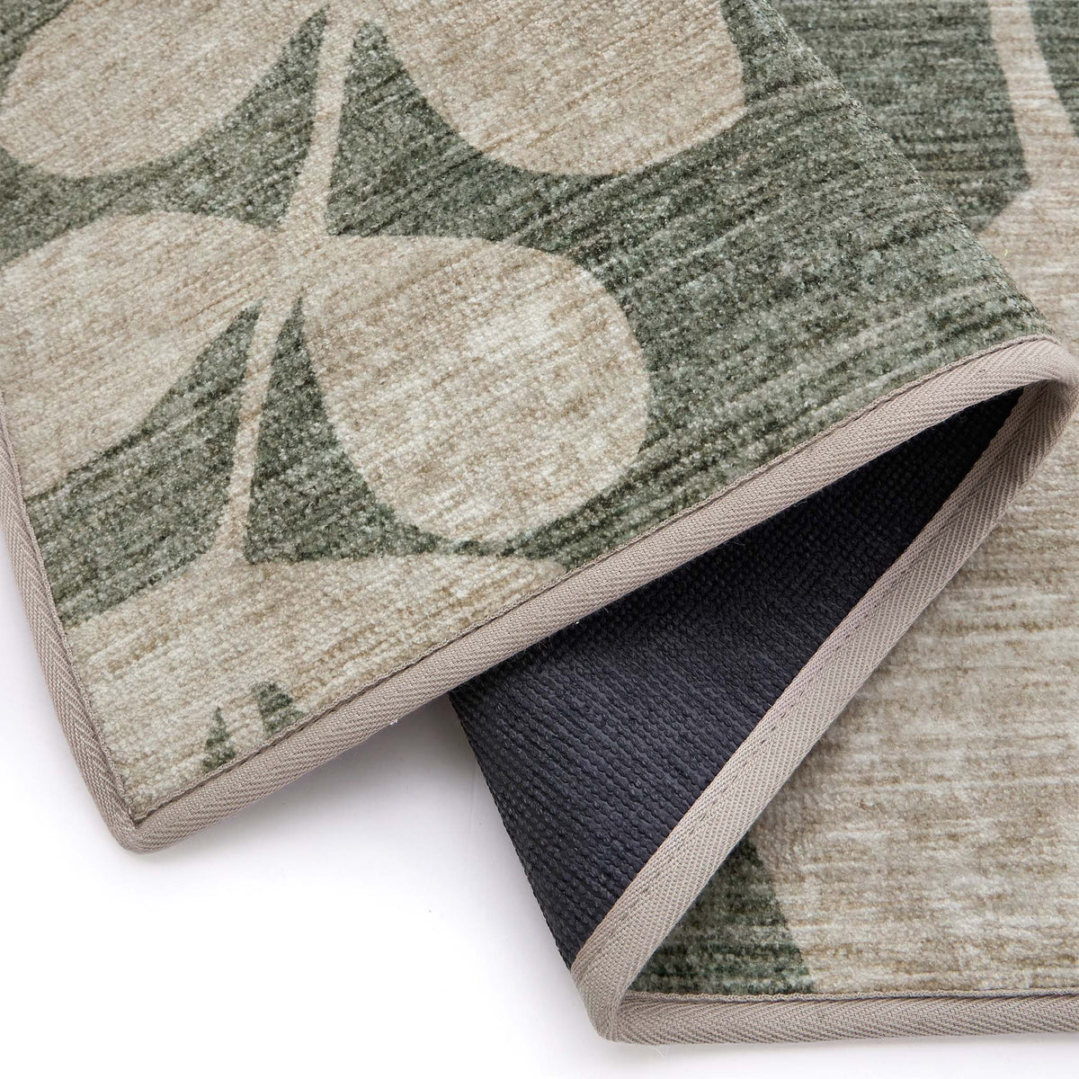 Eden Leaves Green- 100% recycled material rug featuring white florals against a green background.