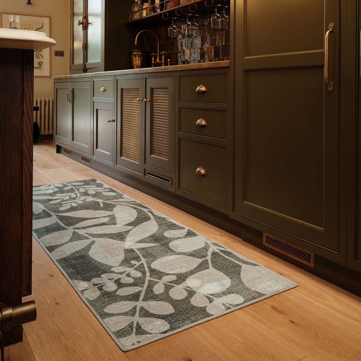 Eden Leaves Green- 100% recycled material rug featuring white florals against a green background.