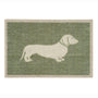 A rectangular doormat with a sage green textured background and a cream-colored silhouette of a dachshund dog, bordered by a cream edge.