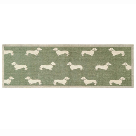 A rectangular runner with a sage green background and a repeating pattern of cream dachshund dogs, finished with a beige woven border.
