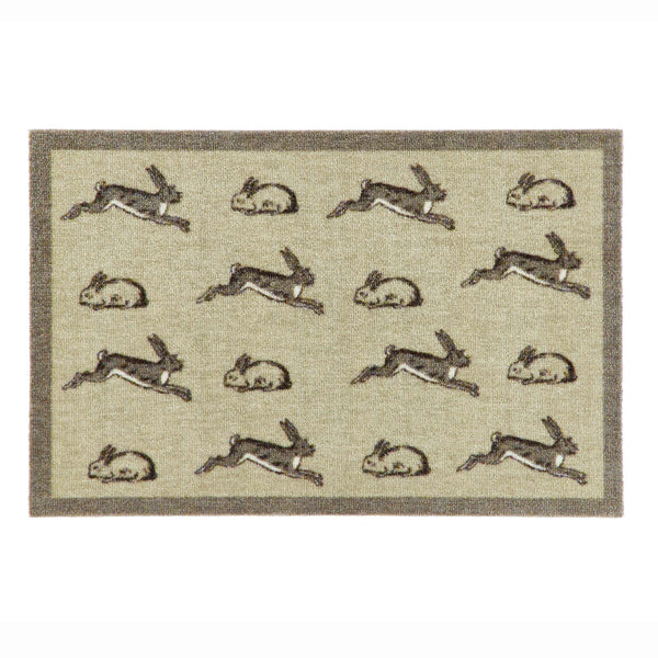 A rectangular doormat with a beige textured background, featuring a border and a repeating pattern of rabbits in gray and brown tones.