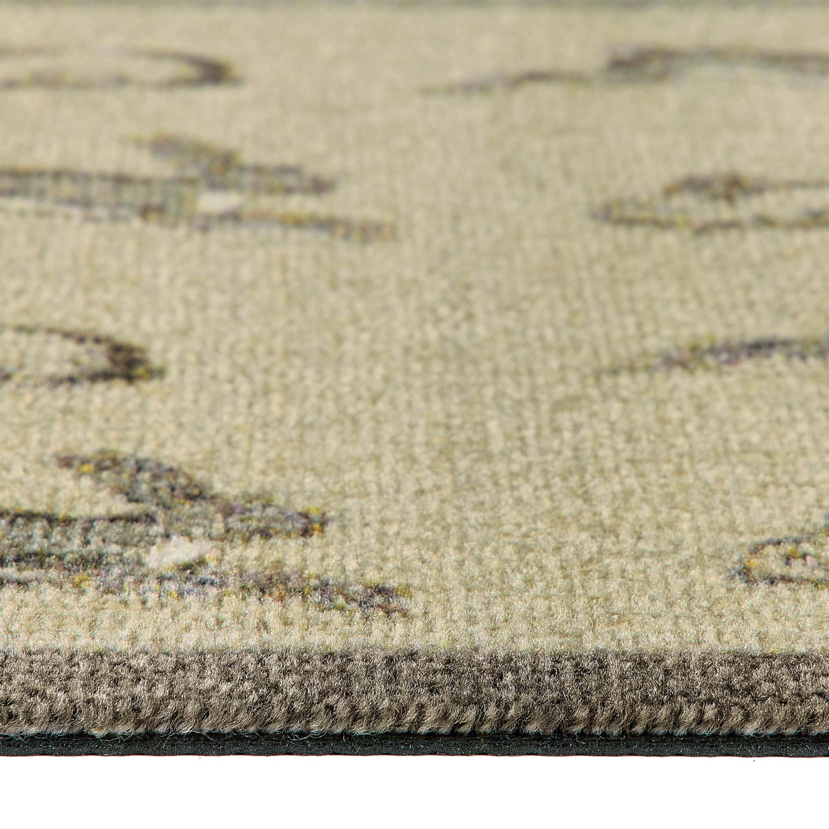 Close-up of a textured doormat showing a beige and taupe patterned surface with a dark charcoal border.