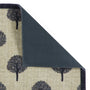A close-up of a doormat dark grey tree pattern, and a dark charcoal underside visible where the corner is folded back, on a white background.