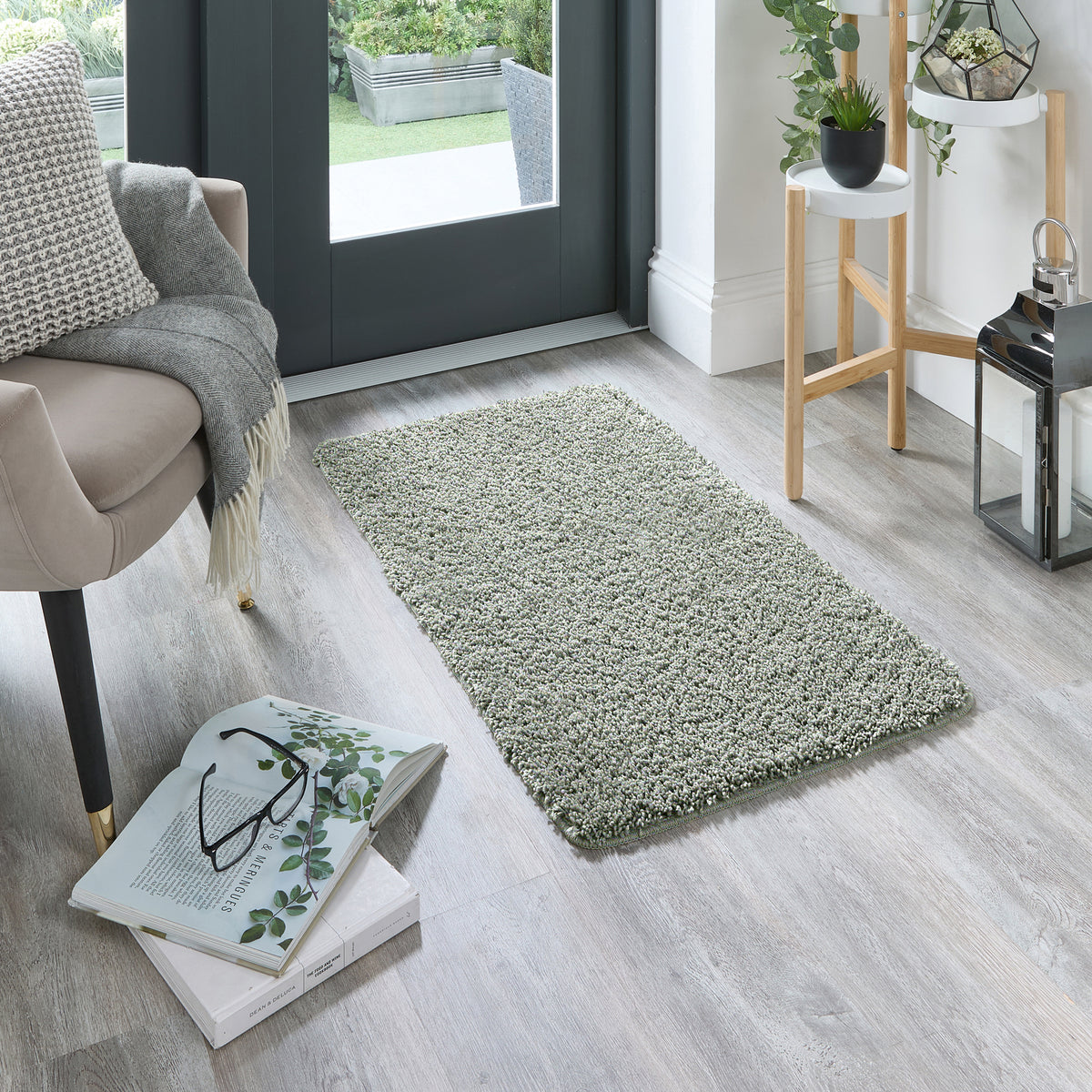 Howler and scratch shaggy green fleck rug with a green shaggy pile. Styled in a doorway.