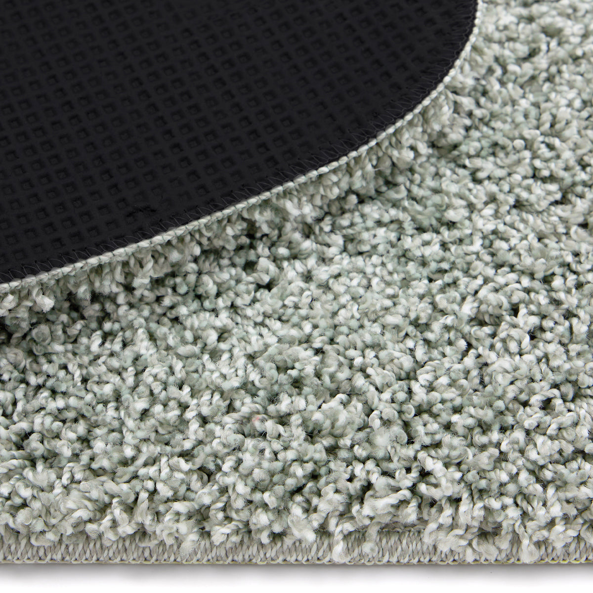 Close-up of Howler and scratch shaggy green fleck rug detail image.