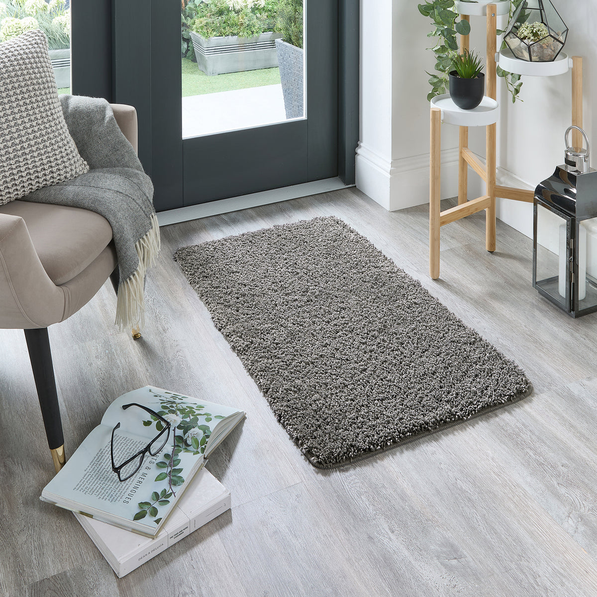 Howler & Scratch grey pet Shaggy mat styled in a doorway. 