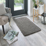 Howler & Scratch grey pet Shaggy mat styled in a doorway. 
