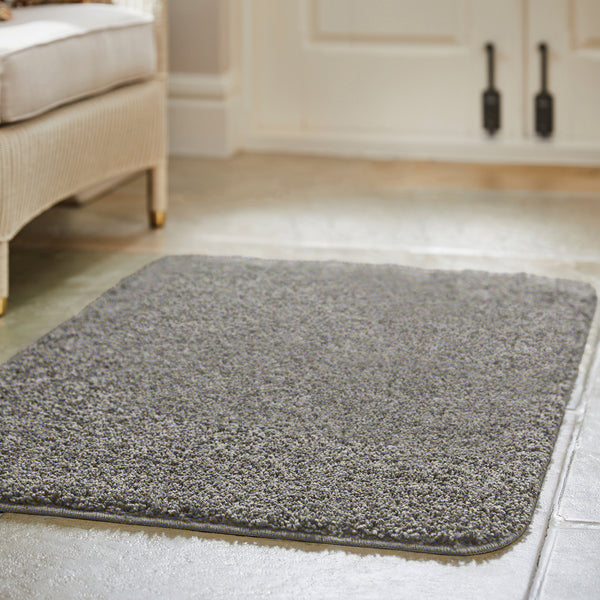 Howler & Scratch grey pet Shaggy mat styled on tiled floor. 