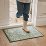 Sanderson By Highgrove x Hug Rug Highgrove Damask Silver Green with a traditional style pattern, styled on tile flooring.