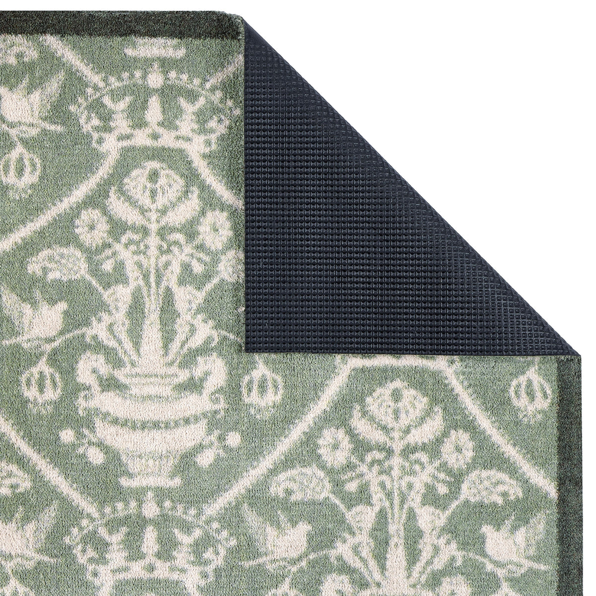 Sanderson By Highgrove x Hug Rug Highgrove Damask Silver Green with a traditional style pattern showing the rubber backing.
