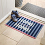A rectangular entryway doormat with navy and light blue vertical stripes, pink edges, and large white text reading “HOME sweet HOME,” shown on a tiled floor at a doorway with shoes placed on it.