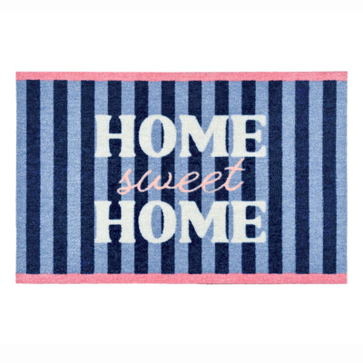 A rectangular doormat with vertical navy, medium blue, and light blue stripes, featuring the words 'HOME sweet HOME' in white and pink lettering, finished with pink borders at the top and bottom.