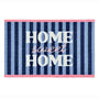 A rectangular doormat with vertical navy, medium blue, and light blue stripes, featuring the words 'HOME sweet HOME' in white and pink lettering, finished with pink borders at the top and bottom.
