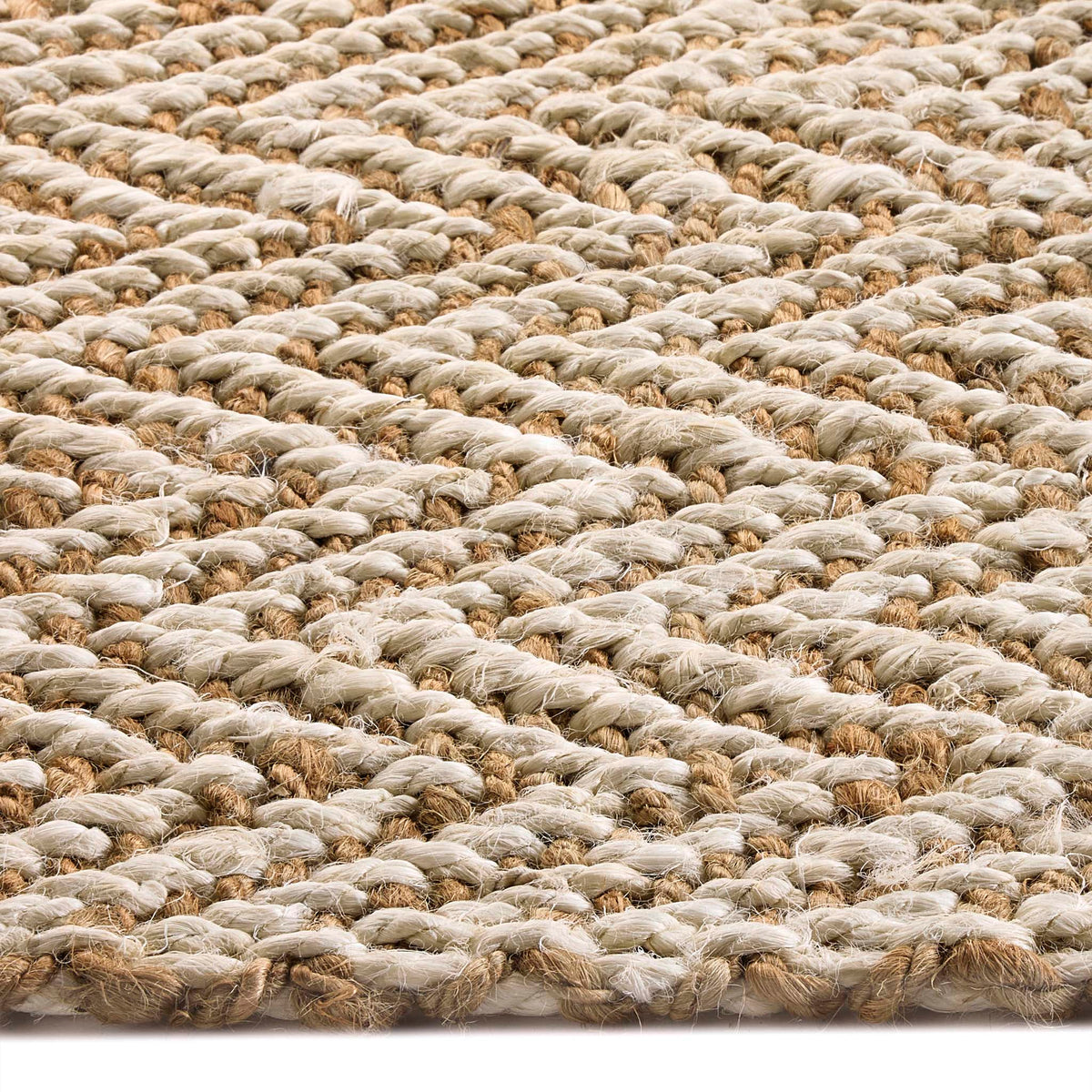 Close-up of Origins Jute Herringbone Doormat with a herringbone woven design.