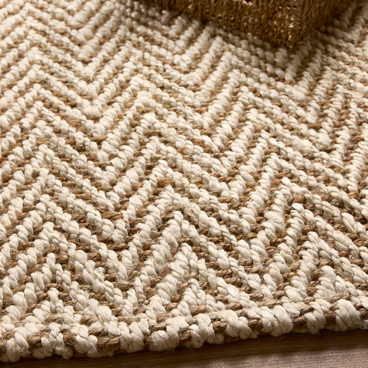 Close-up of Origins Jute Herringbone Doormat with a herringbone woven design.