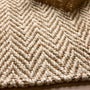 Close-up of Origins Jute Herringbone Doormat with a herringbone woven design.