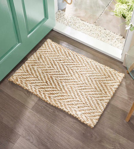 Origins Jute Herringbone Doormat with a herringbone woven design, styled in a doorway.