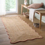 Jute Scalloped Edge Peach Rug- A jute rug with a pink wool wipped edge border.