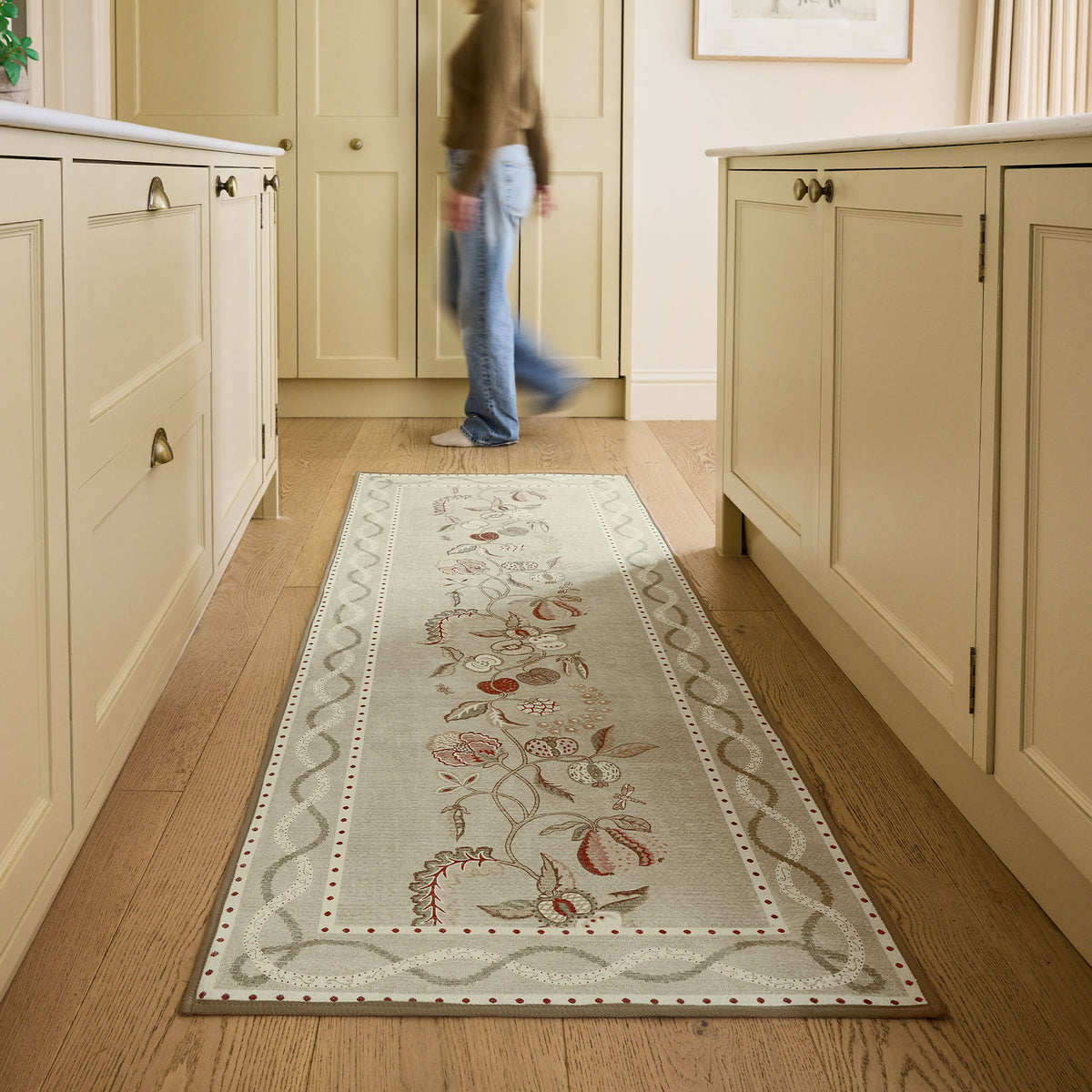 Sanderson By Highgrove x Hug Rug Eco-Washable Kitchen Garden Olive & Russet Runner with a floral design, styled on wooden flooring.