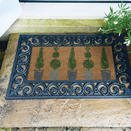 Decorative doormat with decorative border on a stone step