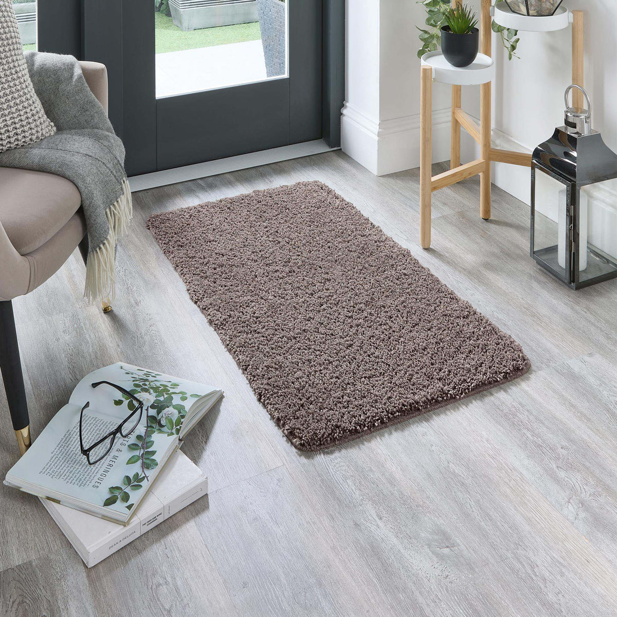 Howler and scratch shaggy pet mat in mocha brown styled in a doorway. 