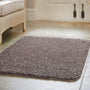 Howler and scratch shaggy pet mat in mocha brown styled on a tiled floor. 
