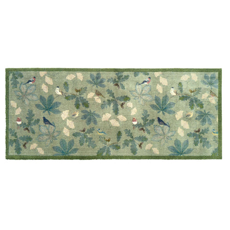 A rectangular area runner with a woodland pattern featuring blue birds, green leaves, and cream-colored acorns on a sage green background, finished with a solid green border.