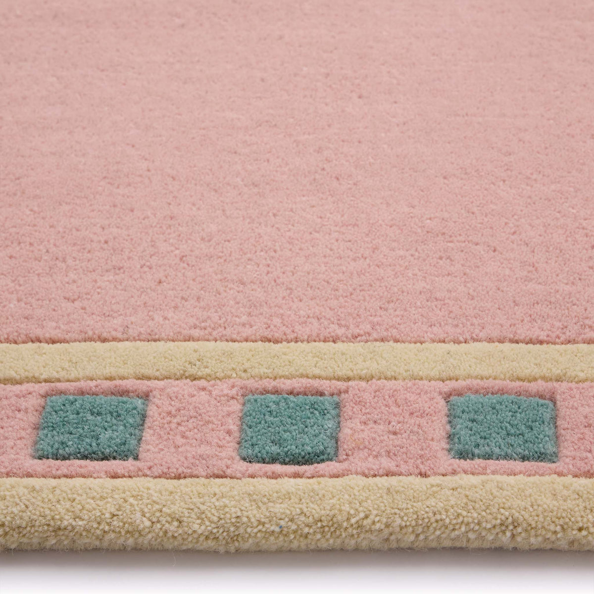 Borderline Pink Rug- 100% wool rug in pink with a geometric border.