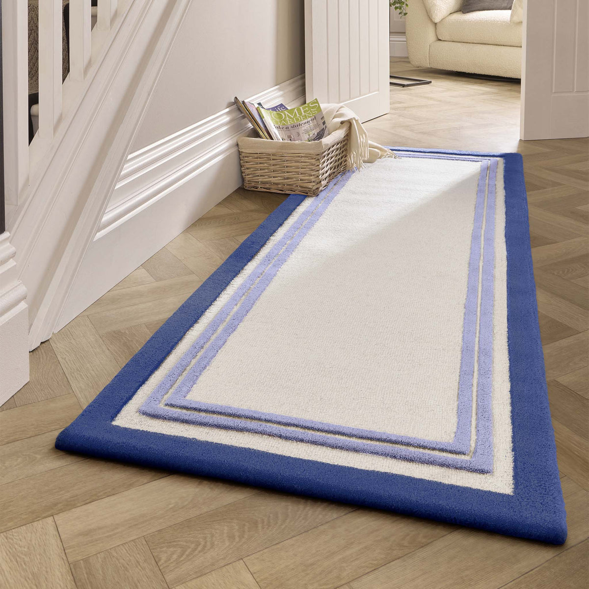 Piper Rug Navy- 100% wool rug with a purple and blue border. 