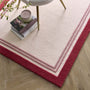 Orgins Piper Raspberry- 100% wool rug with a pink border.