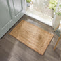 Origins Jute Extra Natural Doormat with a jute woven design, styled in a doorway.