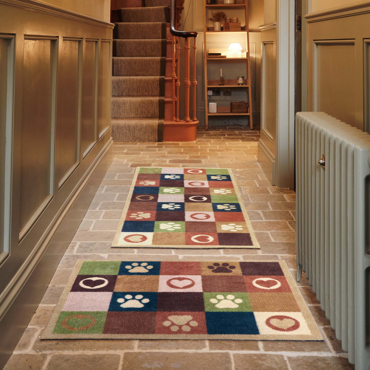 Hug Rug Tartan Paw Green Doormat and Runner with a check pattern with hearts and paw prints, styled in a entryway.