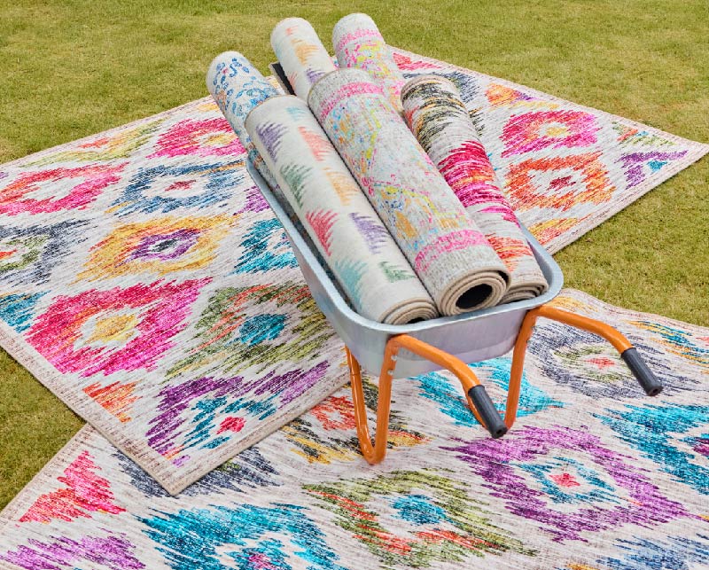 Printed Ikat eco-washable rugs from Hug Rug in a wheelbarrow