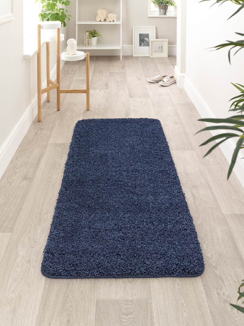 Navy blue My Rug runner in a hallway, manufactured by Phoenox Textiles