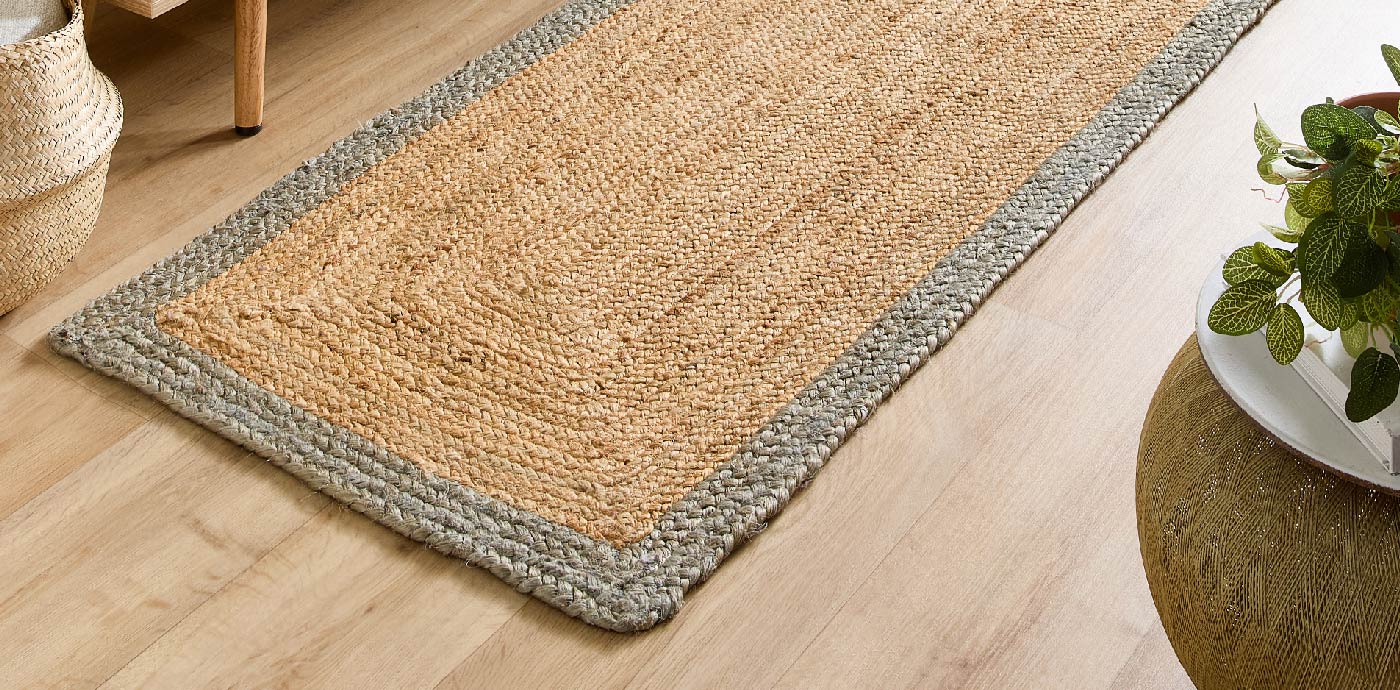 Jute runner rug with grey border on hallway floor, manufactured by Phoenox Textiles